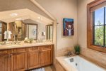  The primary and secondary bedrooms feature a steam shower and a relaxing Jacuzzi tub.